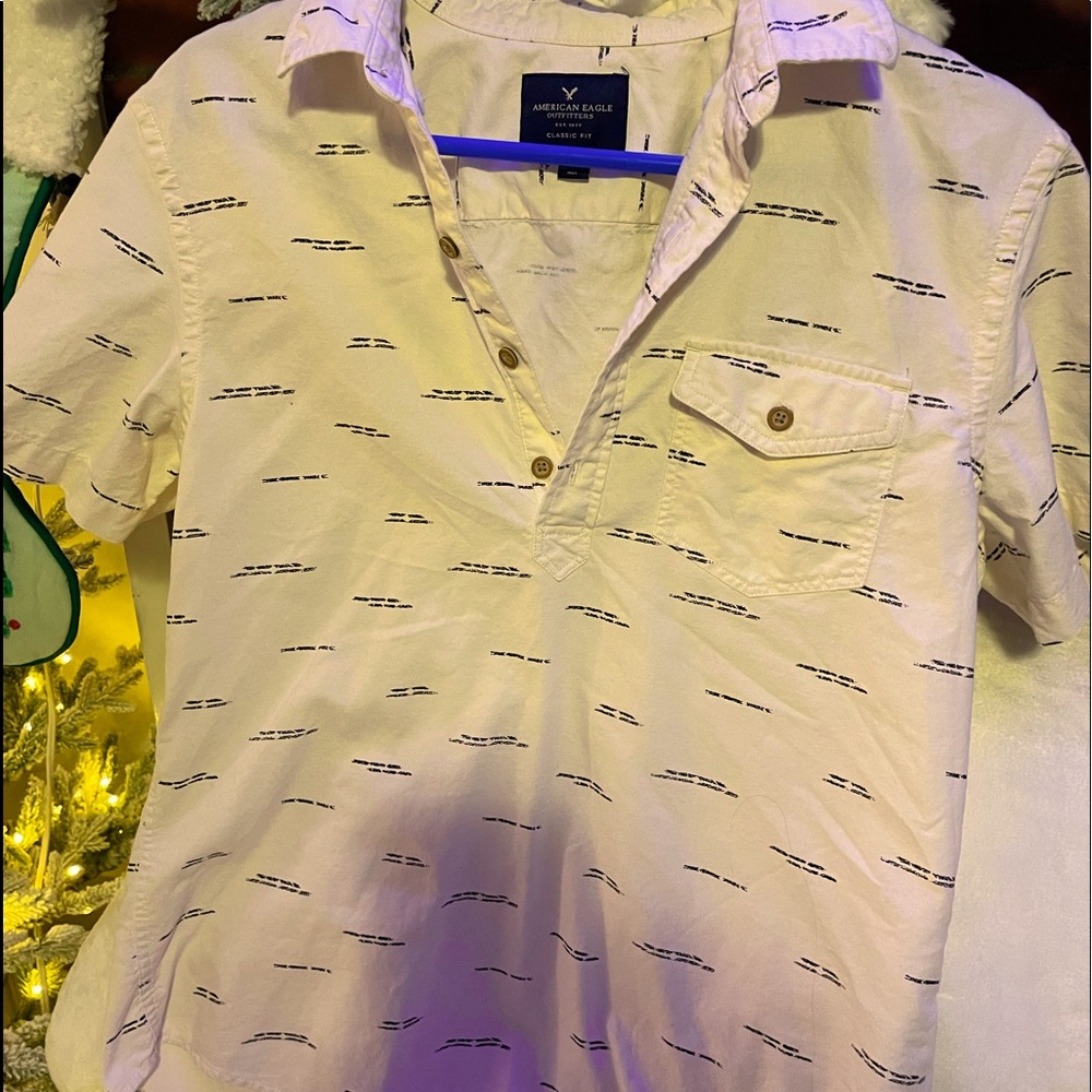 Small cream colored dress shirt.